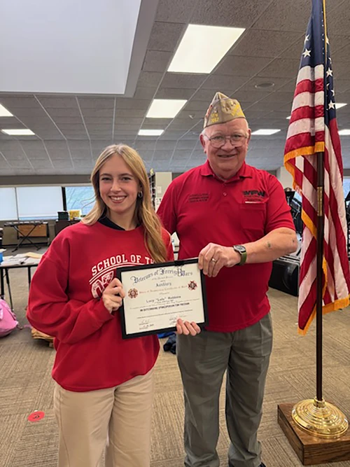 Winner and the veteran smiling with award